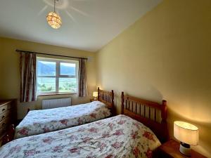 a bedroom with two beds and a window at Twelve Bens Lodge in Recess