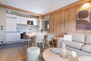 a living room with a couch and a table at Barma Résidence & Appartements in Courchevel
