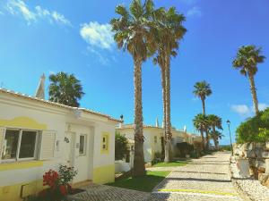 a street with palm trees and a building at Villa Sunrise by MOJE Holiday in Budens