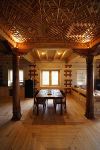 a large room with a wooden table in it at Dera Lamsa Resort Shigar in Shigar