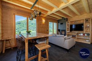 a living room with a table and a couch at Cozy Chalet with Terrace Peaceful Nature Views in Bluffy