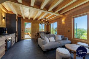a living room with a couch and a table at Cozy Chalet with Terrace Peaceful Nature Views in Bluffy