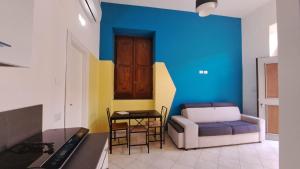 a living room with a couch and a table at Casa Cirillo in Marigliano +7 photos