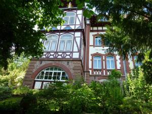a building with a clock tower on top of it at Helsinki Apartment Erfurt 2 in Erfurt