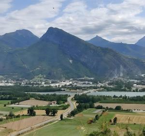 a view of a valley with a river and mountains at Chambre d'hôte l'Argentier in Noyarey