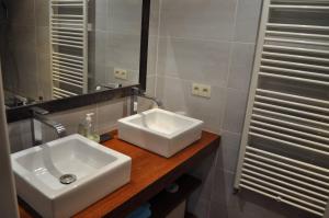 a bathroom with a white sink and a mirror at Chambre d'hôte l'Argentier in Noyarey +4 photos
