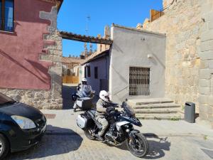 two motorcycles parked on a street next to a building at Casas del Castillo, 2 in Ávila
