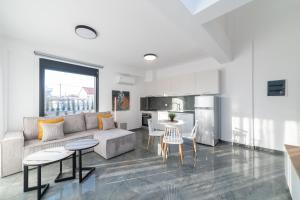 a living room with a couch and a table at Nefeli & Nefeli Luxury Residential Complexes in Ofrínion