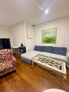 a living room with a couch and a table at Spacious Master Room with Private Ensuite in Melbourne