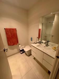 a bathroom with a sink and a toilet and a mirror at Spacious Master Room with Private Ensuite in Melbourne +5 photos