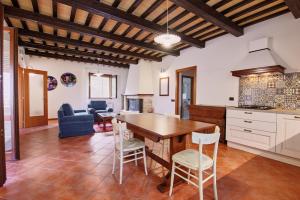 a kitchen and living room with a wooden table and chairs at Villa Elena in San Severino Marche