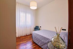 a bedroom with a bed and a vase on a glass table at Villa Elena in San Severino Marche