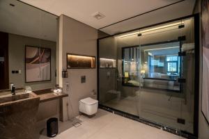 a bathroom with a shower and a toilet and a sink at فندق ليماكو in Najran +36 photos