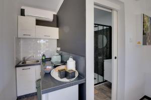 a kitchen with a sink and a counter top at THE SPOT GLAMPING STUDIOS PROTARAs in Paralimni