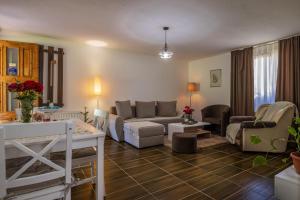 a living room with a couch and a table at Dolina Vekova in Banja +6 photos