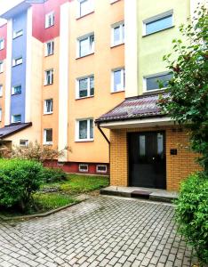 a building with a parking lot in front of it at Sen nad Bałtykiem - Apartament z balkonem, Ustka in Ustka