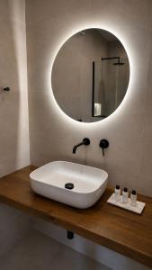 a bathroom with a white sink and a mirror at Salsedo Seaside Rooms 2 in Kanali +18 photos