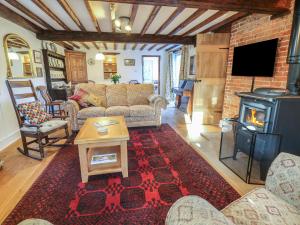 a living room with a couch and a wood stove at 5 Castle Street in Newport