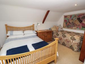 a bedroom with a wooden bed and a couch at 5 Castle Street in Newport