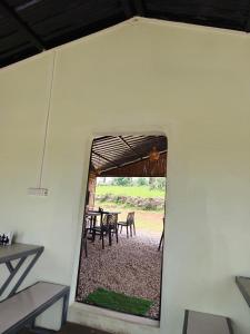 a view of a table and chairs through a window at Heijo's Travellers Nest in Jarain