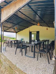 a group of tables and chairs under a pavilion at Heijo's Travellers Nest in Jarain
