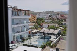 a view from a window of a building with a swimming pool at Hotel Danedi in Ksamil