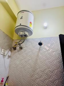a bathroom with a blow dryer on the wall at Awara Hostels and Dormitory in Lucknow +128 photos