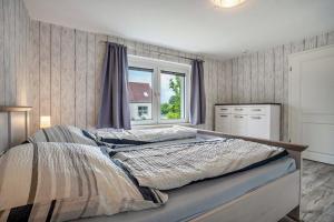 a bedroom with a large bed and a window at Ferienwohnung 2 in Gribow