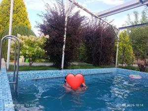 a red heart toy in a swimming pool at Любимый in Cholpon-Ata