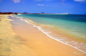 a sandy beach with the ocean and the water at aparthotelboavista-net in Sal Rei
