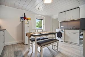 a kitchen with a table and chairs in a room at Ferienwohnung 2 in Gribow +12 photos
