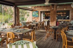 a restaurant with wooden tables and chairs at Finca Hotel Rural Es Turó Spa in Ses Salines