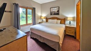 a bedroom with a large bed and a window at Cahilty #149 in Sun Peaks