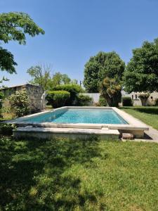 a swimming pool in the yard of a house at Victoria House pool garden in Fourques
