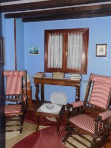 Itsasmin Ostatua في إلانتشوف: غرفة بها كرسيين ومكتب وطاولة
