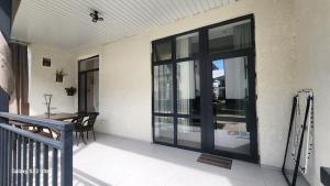 a balcony with sliding glass doors on a house at Коттедж в Sunny Beach in Chok-Tal