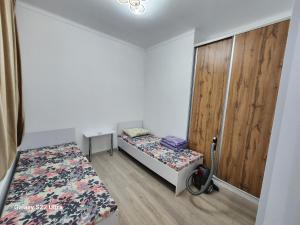 a small room with two beds and a wooden door at Коттедж в Sunny Beach in Chok-Tal