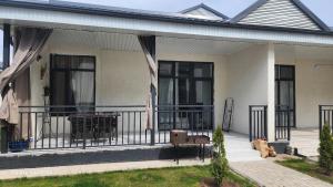 a house with a balcony with a table and chairs at Коттедж в Sunny Beach in Chok-Tal
