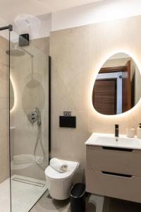 a bathroom with a shower and a toilet and a sink at Kallisti Luxury Rooms in Ierissos +16 photos