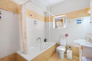 a bathroom with a tub and a toilet and a sink at VALERIA Apartment in Vonitsa +26 photos