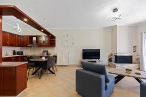 a kitchen and living room with a table and chairs at VALERIA Apartment in Vonitsa