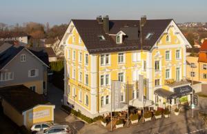 an overhead view of a large yellow building at Ebner - Boutique-Hotel & Konditorei in Lindau