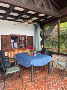 a patio with a blue table and chairs at Seehaus Simssee in Stephanskirchen