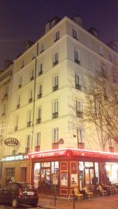 a large white building with a car parked in front of it at Modern Hotel in Paris