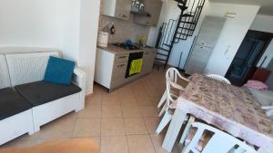 a kitchen and a dining room with a table at Casa Vacanze Sofì in Ascea +14 photos