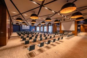 an empty hall with rows of chairs and a stage at Barceló Anfa Casablanca in Casablanca +60 photos