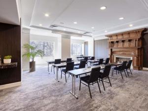a room with tables and chairs and a fireplace at Pullman East Melbourne in Melbourne +209 photos