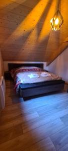 a bedroom with a bed in a wooden attic at Chalet avec jacuzzi privé, 3 chambres in Traubach-le-Haut