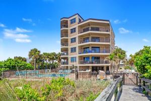 aominium building with a boardwalk in front of it at Gulf Strand Resort 207 in St. Pete Beach