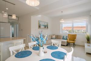 a kitchen and living room with a table and chairs at Myrtiana 10 in Oroklini
